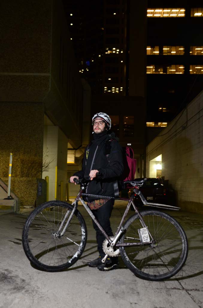 Ben Gervais poses on Tuesday, Feb. 28, 2017 in downtown Calgary where he spends his days as a bike courier . Gervais was hit by a truck in April but can't seem to stay away from the bike life. . (Photo by Sam Hefford/SAIT)